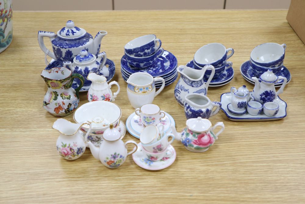 A collection of Victorian Staffordshire childrens blue and white tea ware, in a miniature armoire, height 59cm